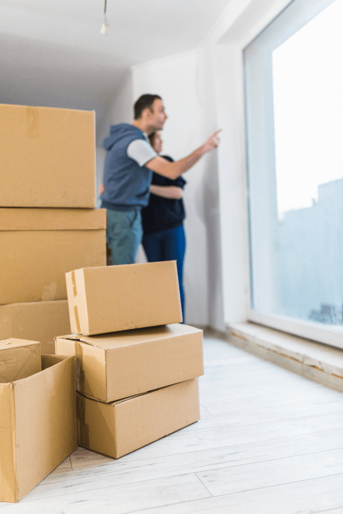 Couple Unpacking Moving Boxes in New Home – Bold Mile Movers